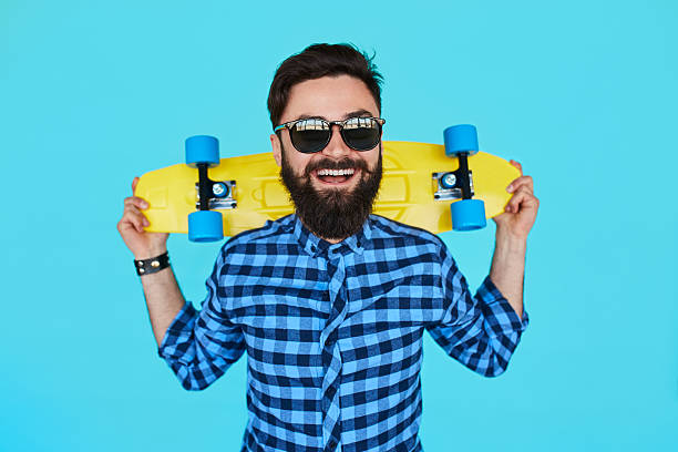 Young hipster man with a skateboard