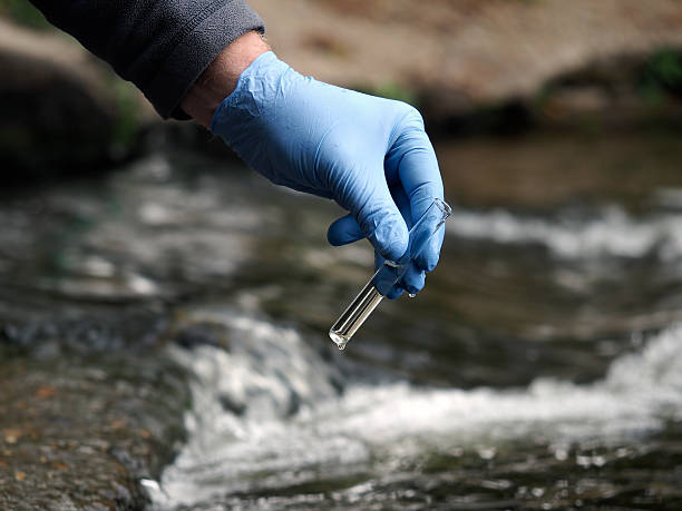 istock Water sample. Gloved hand into the water collecting tube. 610848676