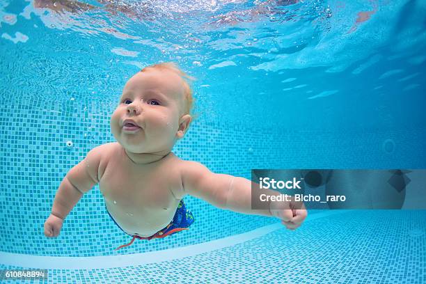 Little Baby Dive Underwater With Fun In Swimming Pool Stock Photo - Download Image Now