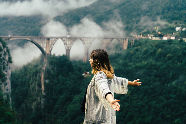istock Woman near the bridge on Tara river 610850596