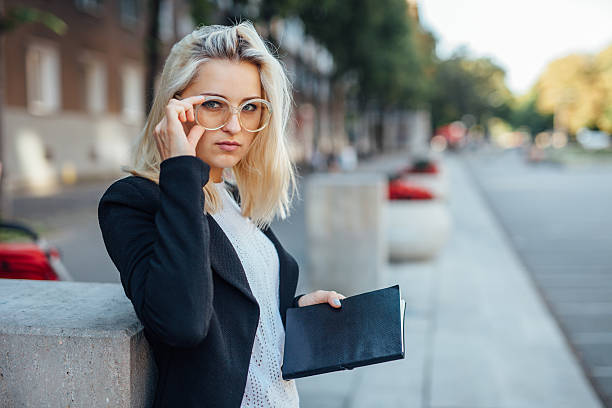 istock Young business woman looking at the camera and holding notepad. 610851344