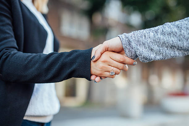 istock Two business woman's hand are greeting with handshake. 610851572
