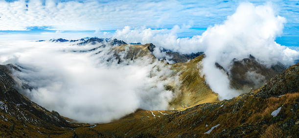 Panoramic view over the snowy mountains of the Highlands in Scotland during an overcast day in winter. Picture taken from Meall Corranaich munro.