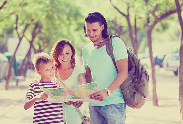 istock family of three searching way at paper map 610853888