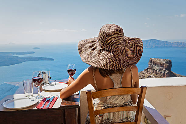 istock Woman in hat drinking red wine 610854114