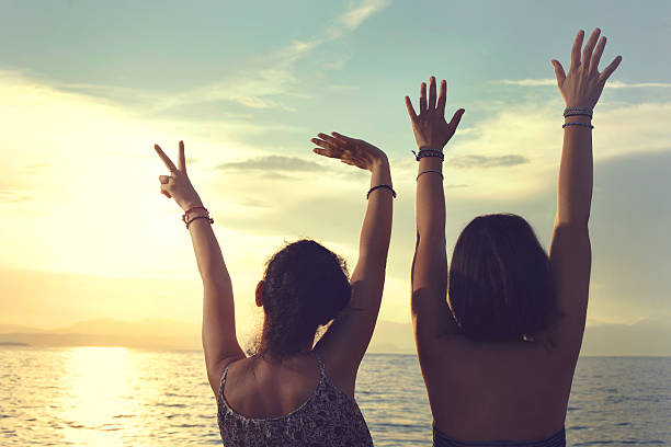 istock young women opened her hands at sunset at sea 610856890