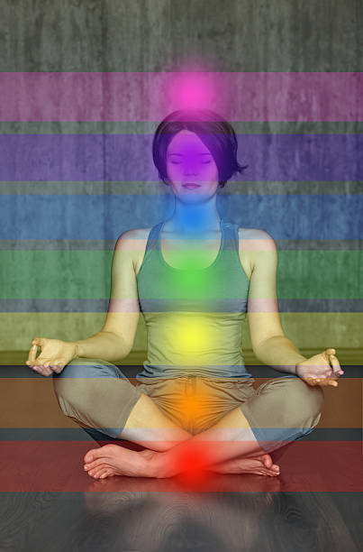 istock Woman practicing meditation with the chakras. Beautiful young  doing yoga 610857142