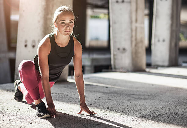 istock Female Athlete Stretching Outdoors 610857404