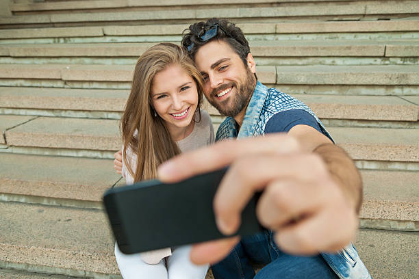 istock Young couple makes his selfie 610859066