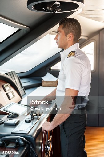 istock Captain operating yacht 610859166