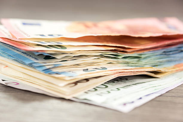 istock Folders with tax documents, money and a pocket calculator 610859586