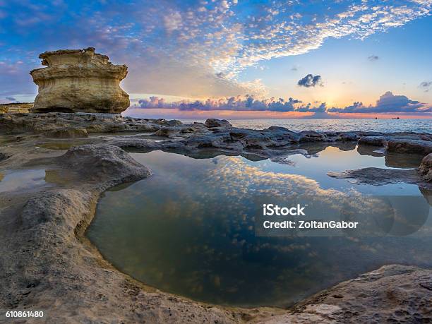 Sunrise At Stpeters Pool With Reflections Of Sky Malta Stock Photo - Download Image Now