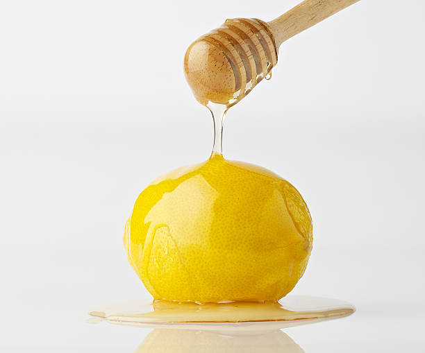 istock isolate dripping organic honey with lemon on white background 610861890