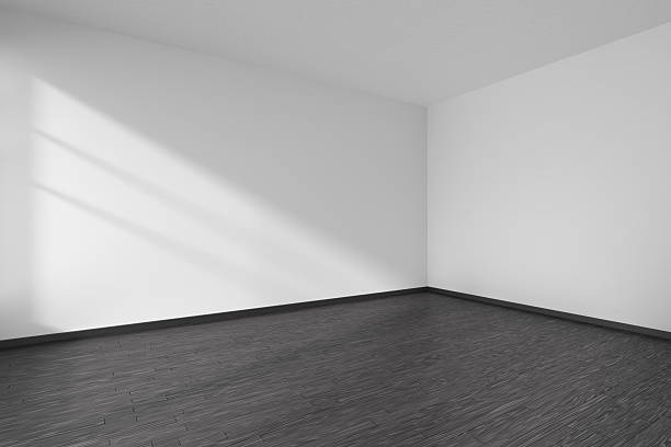 istock Corner of empty white room with black parquet floor 610862664