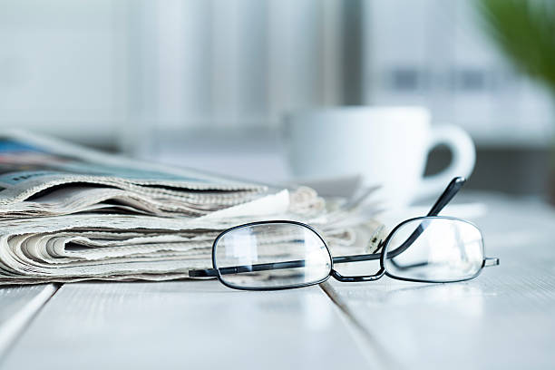 istock Stack of newspapers and eyeglasses 610863018