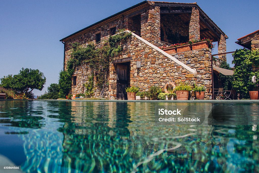 Italian Holiday Villa Landscape image of a holiday villa with an infinite pool. Vacation Rental Stock Photo