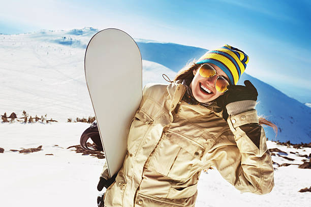 istock Happy girl snowboarder having fun 610866110