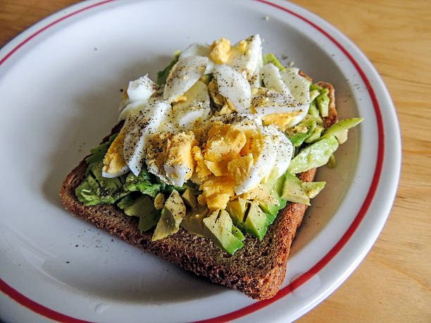 Healthy food. Avocado with free range egg on brown bread