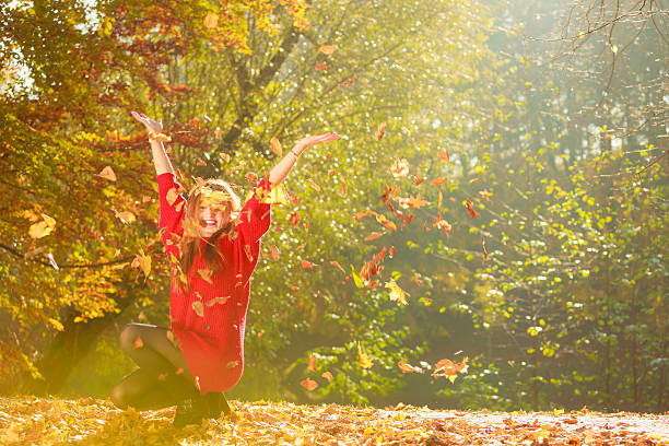 istock Crouching girl in autumnal forest. 610867706