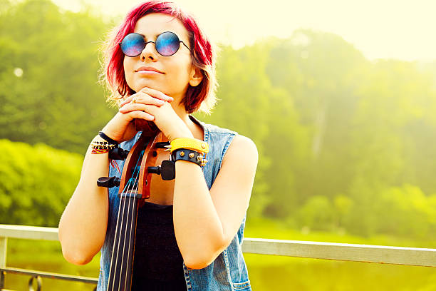 Street musician playing the cello in city park