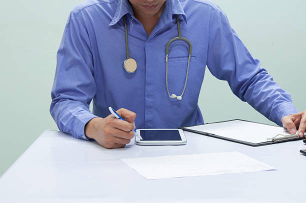 istock Doctor writing a medical prescription. 610868644
