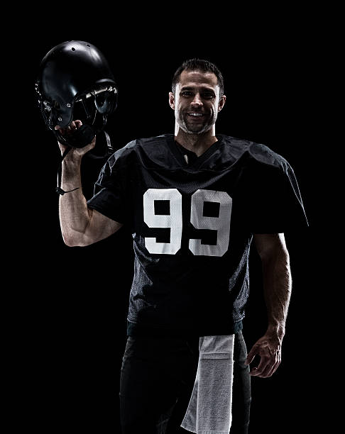 istock Smiling American football player standing 610868696