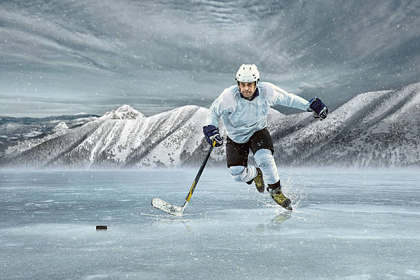 istock Ice hockey player on the ice in mountains 610869526