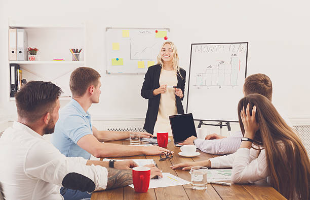 istock Project presentation. Young hipsters businessmen and women at mo 610869918