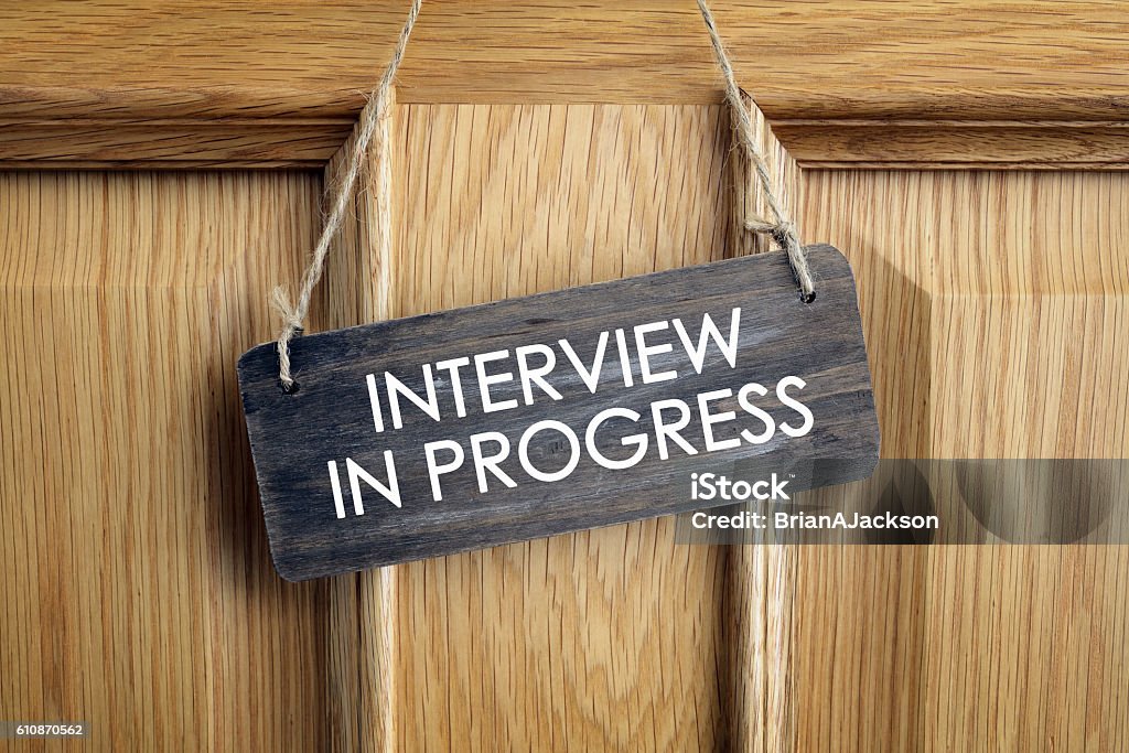 Interview in progress sign on office door Interview room door concept for recruitment or medical checkup with a consultant Job Interview Stock Photo