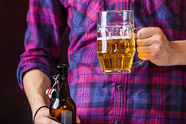 istock Man holds glass of beer. 610870908