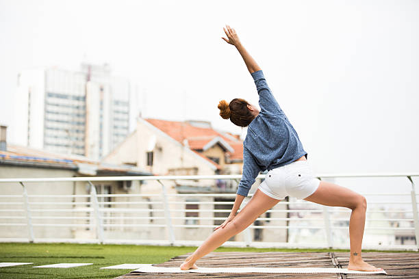 istock Beautiful woman doing yoga outdoors on a rooftop terrace 610871278