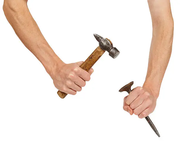 Photo of Male hands working with hammer and chisel