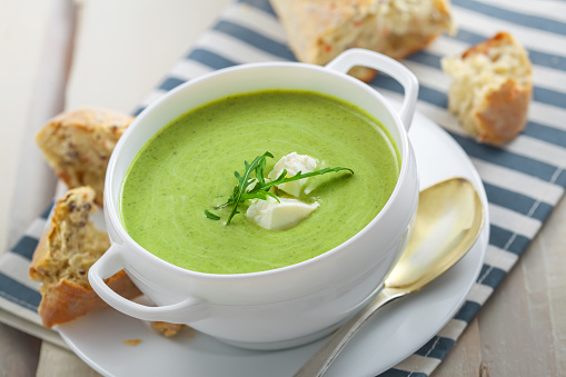 Delicious broccoli cream soup with rye bread . International cuisine meal.