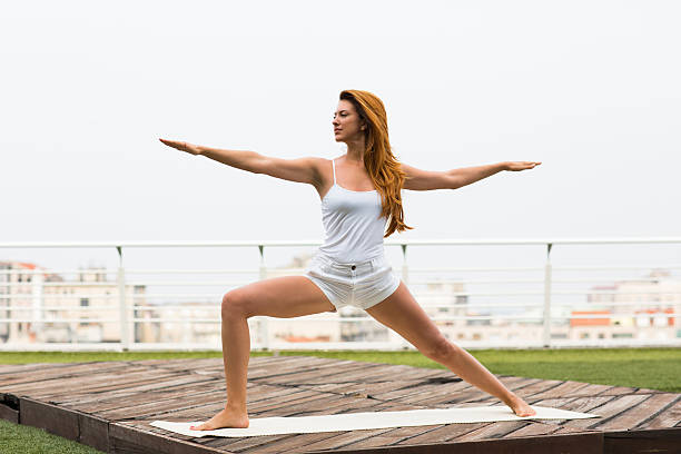 istock Beautiful woman doing yoga outdoors on a rooftop terrace 610872228