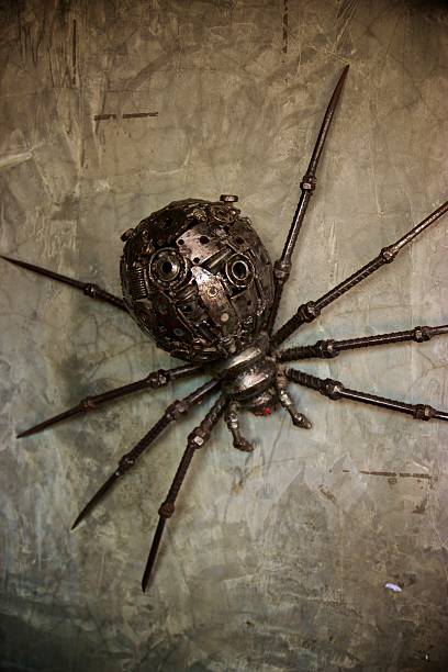istock Steel sculpture Black widow spider perched on a wall 610872860