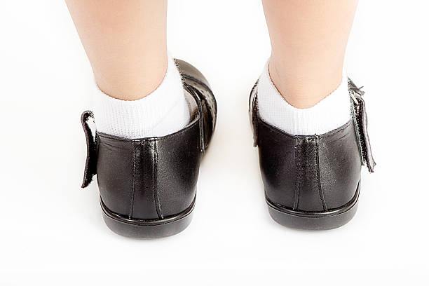 istock Young School Girl Student Wearing Black Shoes - Back View 610874468