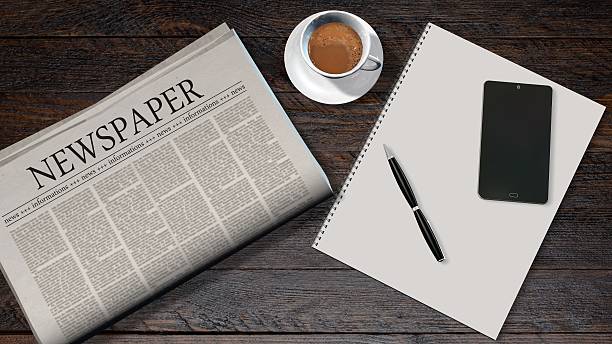 istock office table with newspaper and the headline newspaper 610874532