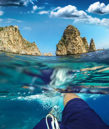 Swimming on the coastline beautiful sea in Italy - Sicily. Image shot by a personal point of view pos