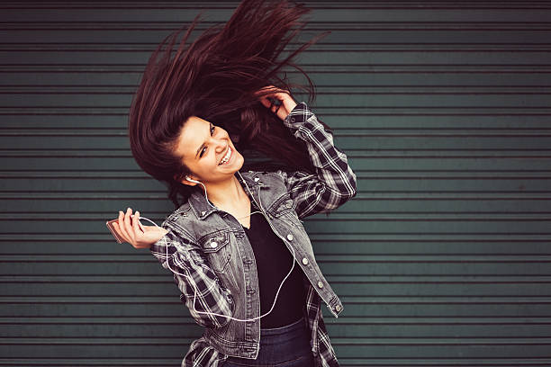 istock Happy girl with mp3 player 610875240
