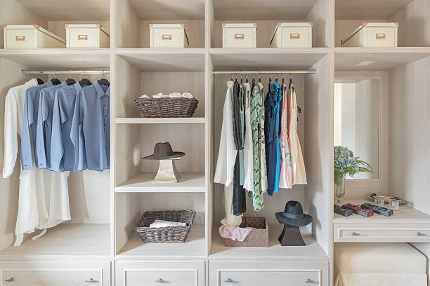 istock modern wooden wardrobe with clothes hanging on rail 610876488