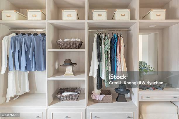 Modern Wooden Wardrobe With Clothes Hanging On Rail Stock Photo - Download Image Now