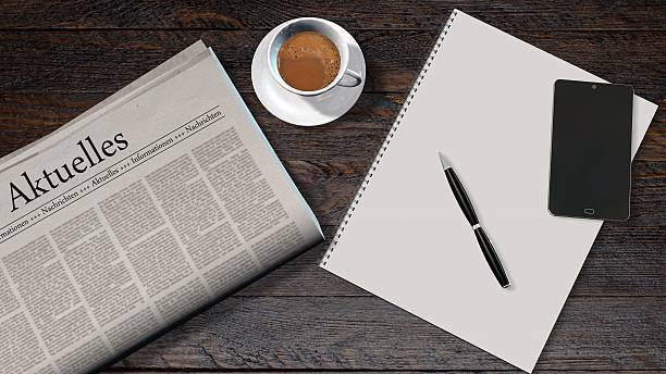 istock office table with newspaper and the german headline news 610876528