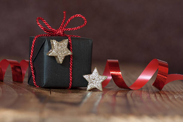 Still life with Christmas Gift Still life with a gift for Christmas red bow and stars funkeln stock pictures, royalty-free photos & images