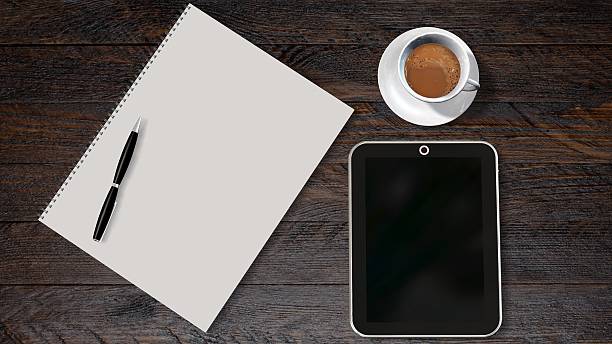 office table with tablet pc coffee and paper drawing pad