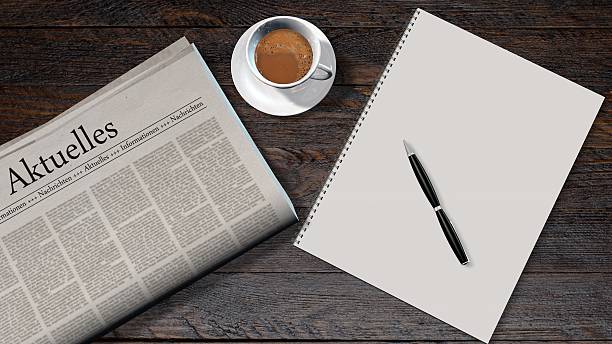 istock office table with blank newspaper and the german headline news 610877698