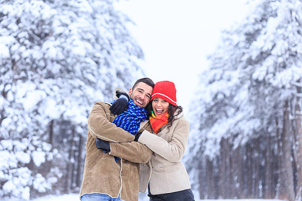 istock Cheerful couple having fun in snow forest 610877730