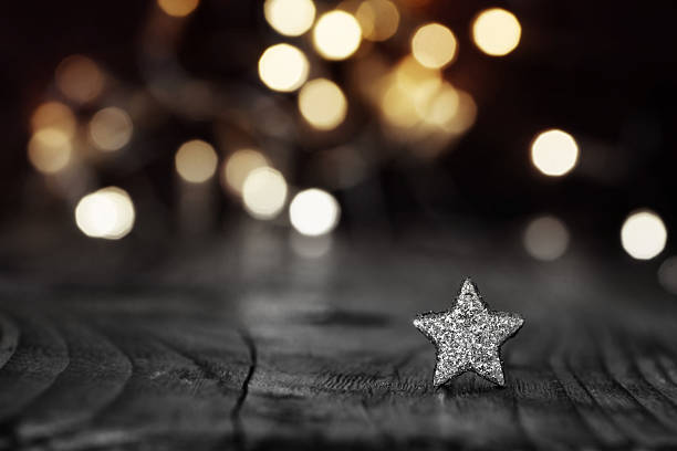 Silver Star on festive background Silver christmas star in front of a festive background with golden lights stars in your eyes stock pictures, royalty-free photos & images