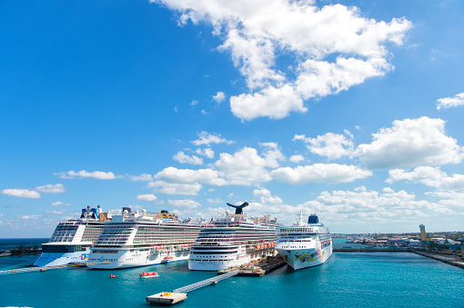 Miami, FL, USA - January 26, 2022: View of the cruise ship fleet in port, waiting for tourists, in the Port of Miami, one of the busiest ports in the United States. Miami is a city famous for hosting cruise tourism in the Caribbean.