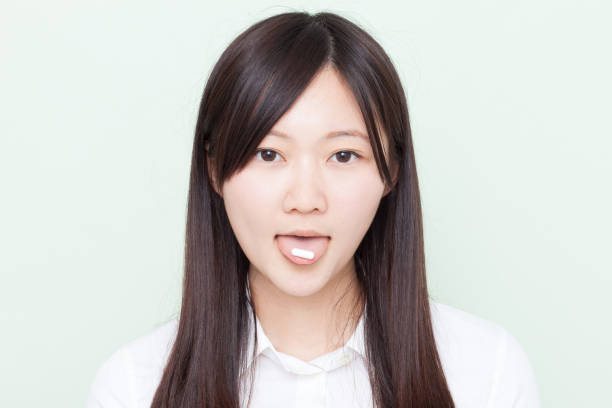 istock Japanese woman with pill 610879428
