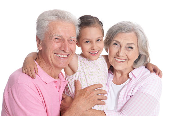 Happy grandparents with granddaughter on white background